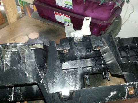 1994 Ford Bronco - Close-up of a disassembled dashboard part with visible mounting points.