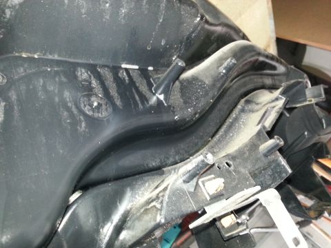 1994 Ford Bronco - Close-up view of detached black plastic dashboard trim components with visible mounting posts and dust accumulation.