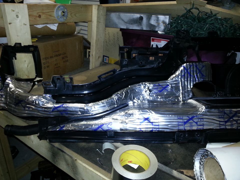 Dashboard part with silver sound deadening material and blue X's