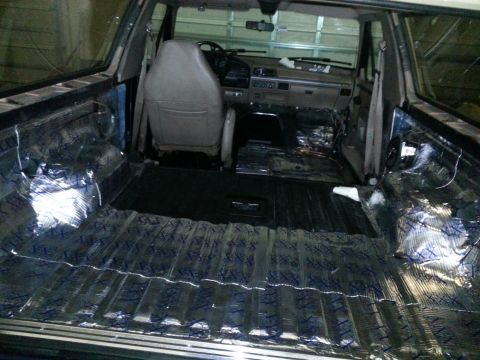 1994 Ford Bronco - The interior of a vehicle is being prepped for sound deadening material installation.