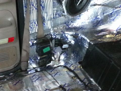 1994 Ford Bronco - Sound dampening material is applied to the interior of a vehicle, obscuring most of the original components.