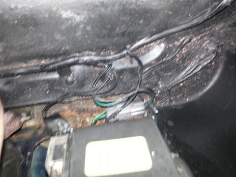 1994 Ford Bronco - Close-up of vehicle wiring and a junction box, likely in an interior compartment.