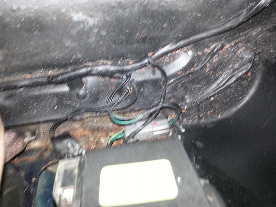 Vehicle wiring harness and a black junction box with a yellow label