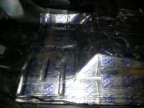 1994 Ford Bronco - The interior floor of a vehicle is covered with sound deadening material.
