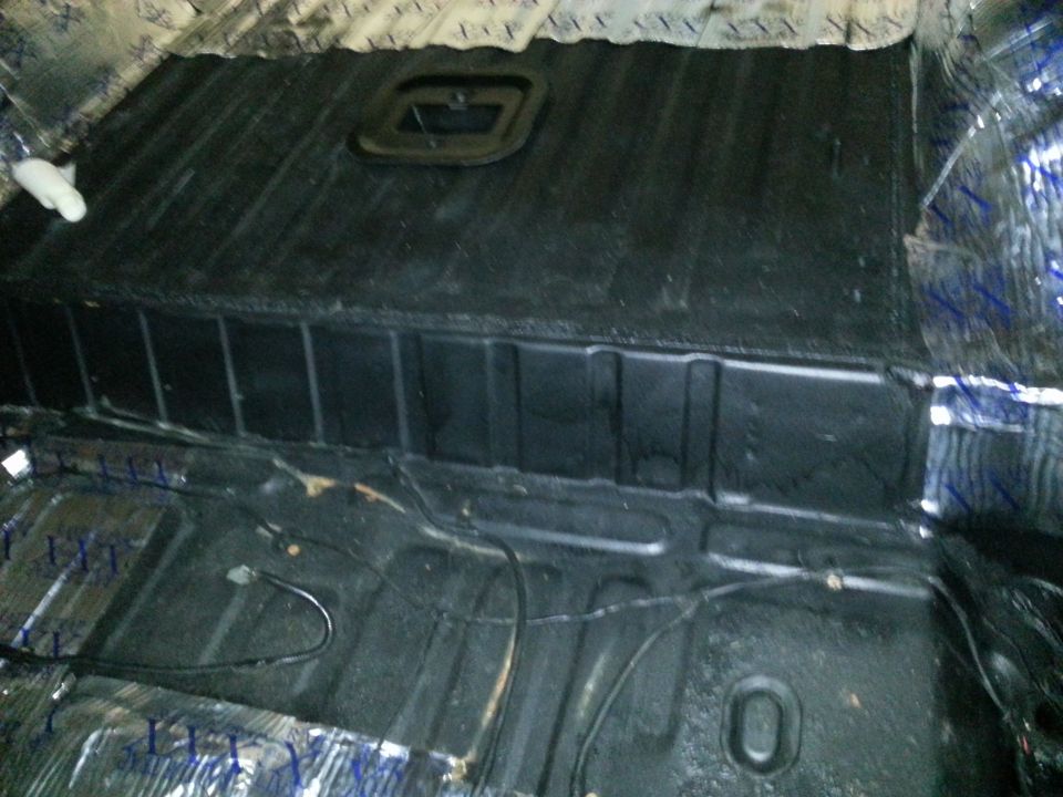 Vehicle interior floor with sound deadening material and wiring