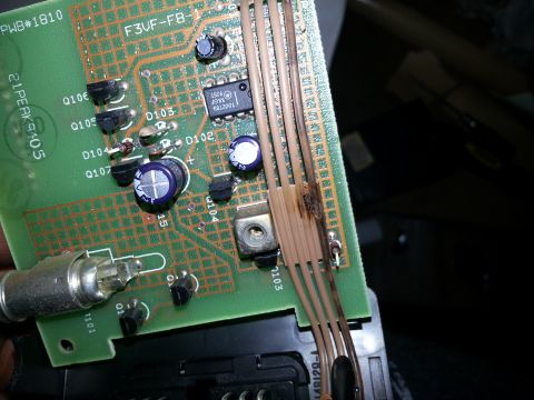 1994 Ford Bronco - Circuit board with visible damage to wires and components.