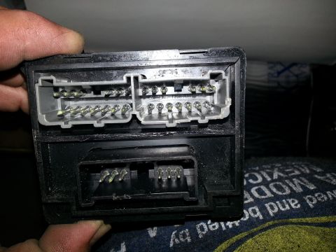 1994 Ford Bronco - Two electrical connectors from a vehicle's control module are shown, with pins exposed.