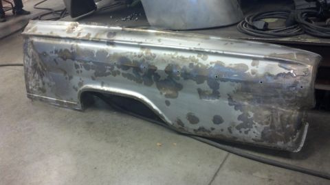 1964 Ford Fairlane - This car fender is being prepped for restoration, showing signs of rust and previous repairs.
