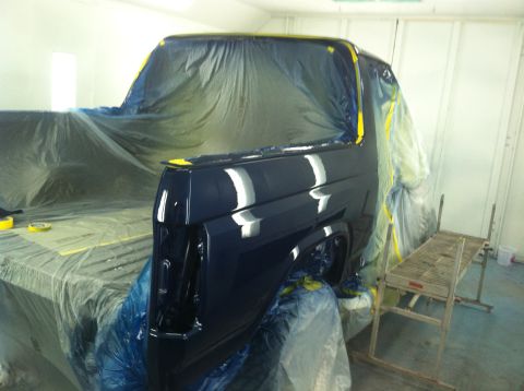 1982 Ford Bronco - Ford Bronco body undergoing paint work inside a professional spray booth.