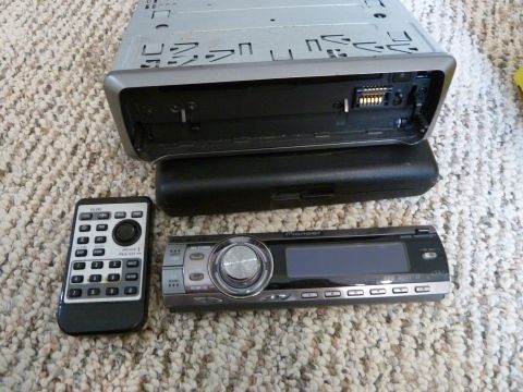 2007 Subaru Impreza - Car stereo components including a Pioneer head unit and remote are laid out on a carpeted surface.