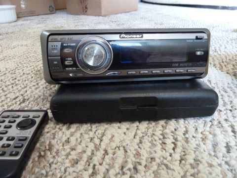 2007 Subaru Impreza - A Pioneer car stereo unit and its remote control are shown resting on a carpeted surface.