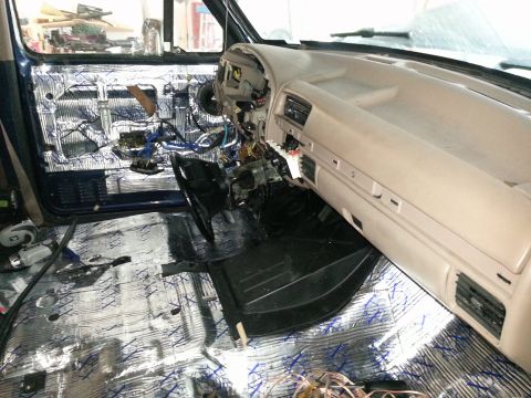 1994 Ford Bronco - Interior of a 1994 Ford Bronco showing sound deadening installation on the door and floor.