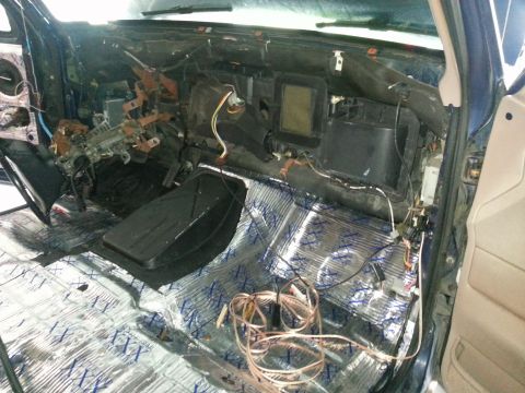 1994 Ford Bronco - Vehicle interior with dashboard removed, exposing internal components and wiring.