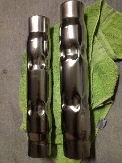 2013 Ford Mustang - Two chrome exhaust pipes with distinctive dimpled sections are shown on a green towel.