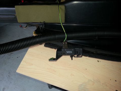 1994 Ford Bronco - A close-up view of an interior vehicle part labeled 5115, with a black ribbed hose nearby.