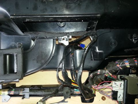 1994 Ford Bronco - Wiring harness and ducting visible inside a vehicle's dashboard area.