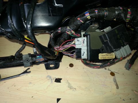 1994 Ford Bronco - A close-up view of a vehicle's complex wiring harness and electronic control modules, likely from the dashboard area.