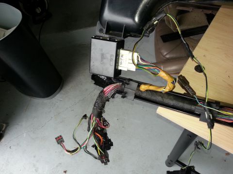 1994 Ford Bronco - Close-up of a vehicle's wiring harness and control module, likely removed for repair or replacement.