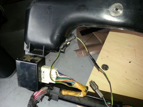 1994 Ford Bronco - A close-up view of a vehicle's complex wiring harness, showing a junction box and numerous colorful wires.