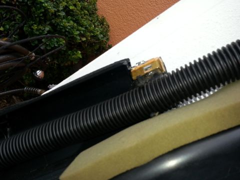 1994 Ford Bronco - Close-up view of a vehicle's dashboard wiring harness, black corrugated tubing and yellow foam padding.