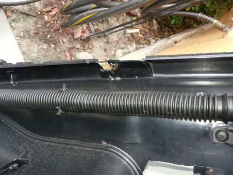 1994 Ford Bronco - A section of the dashboard trim is shown with a wire loom and some exterior wiring.