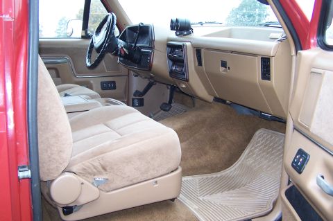 1990 Ford Bronco - Interior view of a 1990 Ford Bronco, tan upholstery and dashboard details.