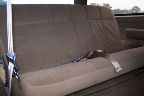 1990 Ford Bronco - Interior view of a brown fabric rear bench seat with seatbelts.