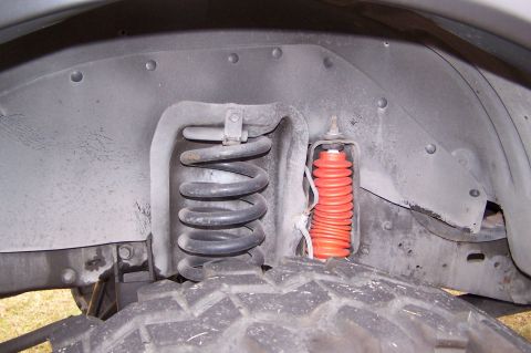 1990 Ford Bronco - This photo shows the suspension components inside the front wheel well of a vehicle.
