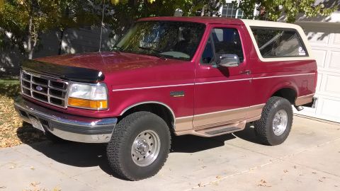 1995 Ford Bronco - This 1995 Ford Bronco is shown from a three-quarter front angle, parked outdoors on a paved surface.