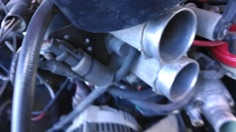1995 Ford Bronco - This is a close-up view of the engine's throttle body and intake system.