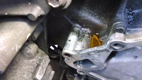 1995 Ford Bronco - Close-up view of an engine component showing an oil leak.