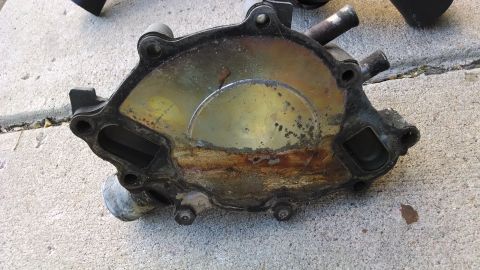 1995 Ford Bronco - A used water pump shows significant corrosion and rust on its internal components.