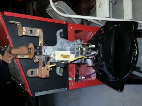 1994 Ford Bronco - Close-up of a vehicle's steering column assembly, showing the ignition switch and wiring harness.