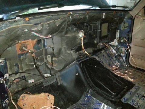 1994 Ford Bronco - The interior of a 1994 Ford Bronco is shown with the dashboard removed, revealing wiring and components.