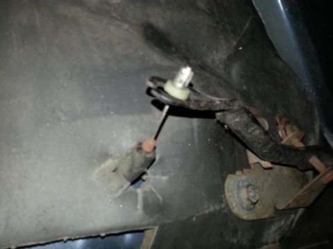 1994 Ford Bronco - Detail of a cable and bracket assembly, likely an interior vehicle component.