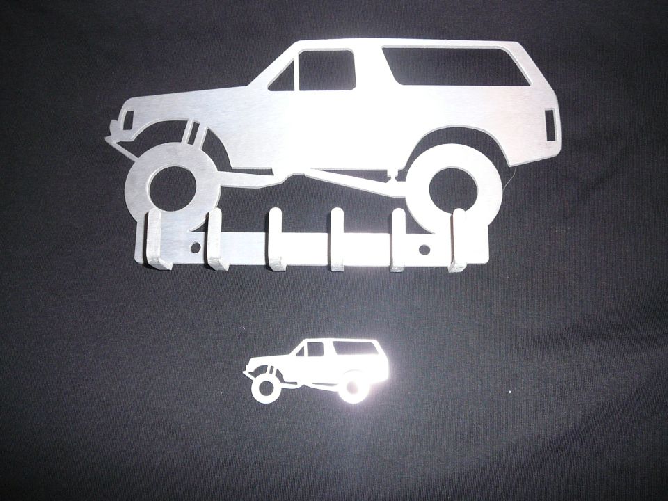 metal silhouette of a lifted Bronco with hooks, and a smaller Bronco silhouette