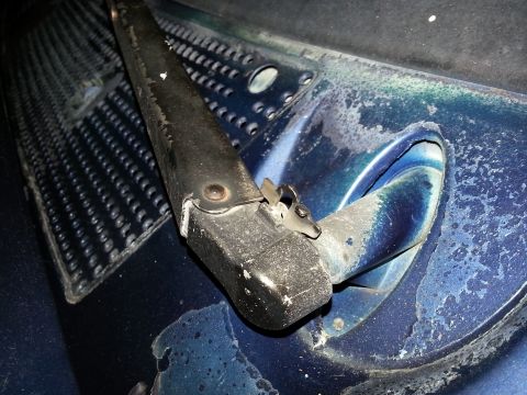 1994 Ford Bronco - Close-up view of the wiper arm base on the cowl of a 1994 Ford Bronco.