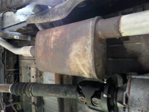 1992 Ford Bronco - The photo shows the underside of a vehicle, focusing on the exhaust system and driveshaft components.