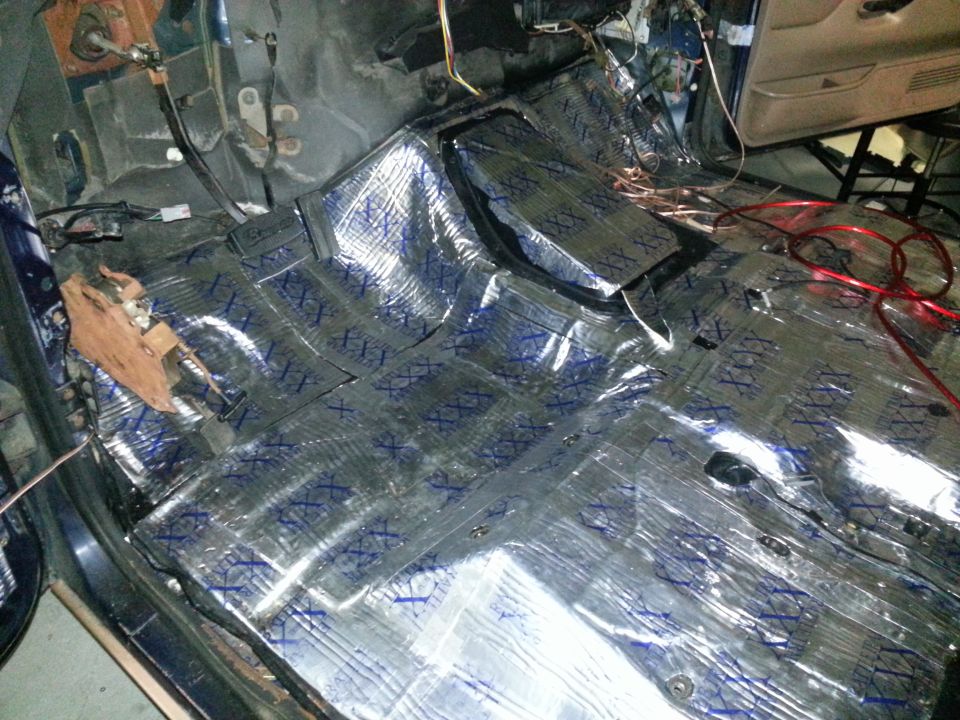 Interior floor covered in sound deadening material, wires visible