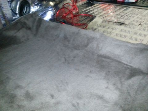 1994 Ford Bronco - Close-up of vehicle carpet with some wires and reflective material visible in the background.