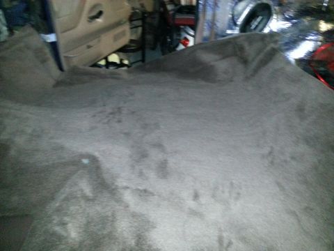 1994 Ford Bronco - The carpet and interior door panel of a vehicle are visible in this close-up shot.