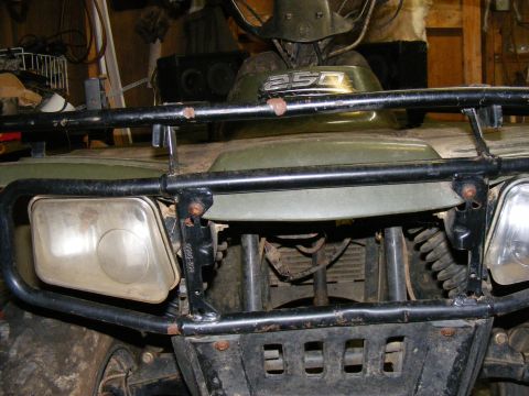 Green ATV with a black roll cage and headlights. The number 250 is visible on the front