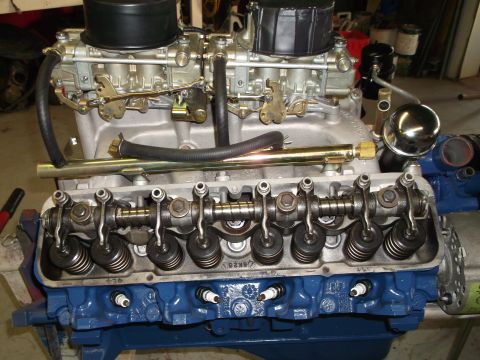 1967 Ford Mustang - Close-up view of a V8 engine dual carburetors and a blue painted engine block.