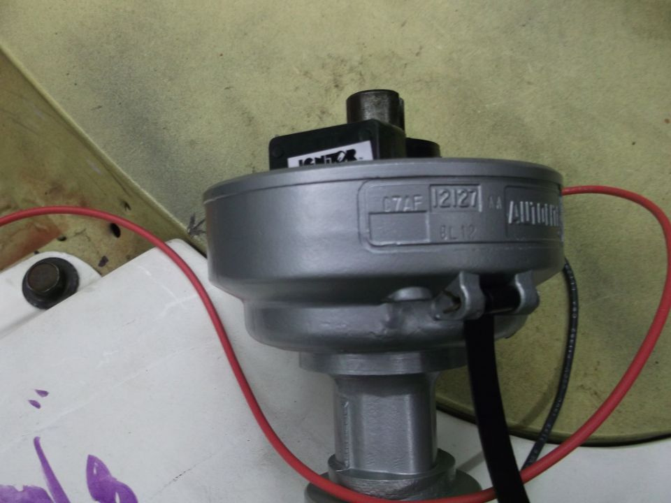 Silver distributor with 'IGNITOR' label and part number 'C7AF 12127'