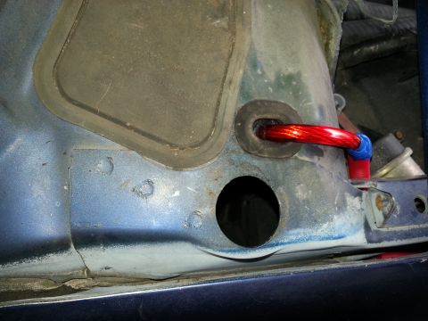 1994 Ford Bronco - Wiring for a car's stereo system passes through a firewall grommet.