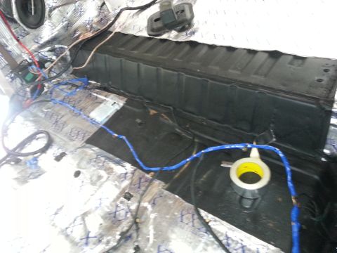 1994 Ford Bronco - Vehicle interior shows extensive wiring and sound dampening material on the floor.