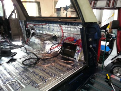 1994 Ford Bronco - Vehicle interior being prepped for an audio system installation, showing sound dampening and wiring.
