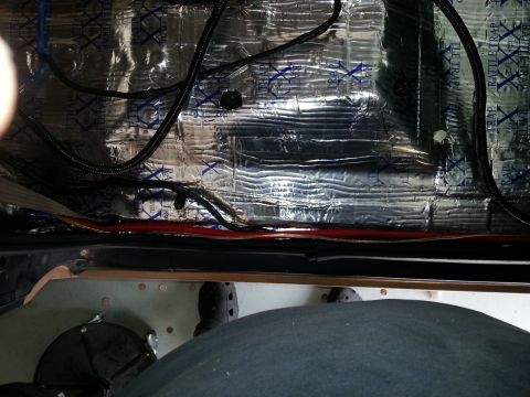 1994 Ford Bronco - Photograph of a truck interior rocker channel covered in foil sound-deadening with wiring, not a technical document.