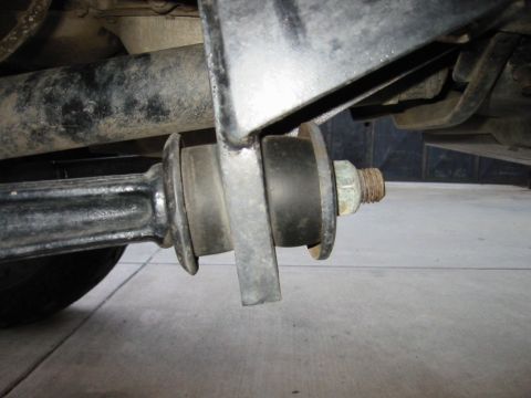 1985 Ford Bronco - This image shows a close-up of a vehicle's suspension system, focusing on a bushing and bolt assembly.