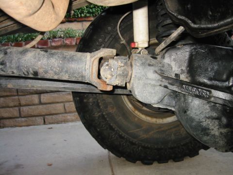 1985 Ford Bronco - Close-up view of the undercarriage of a vehicle, focusing on the drivetrain components.